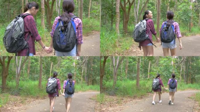 走在森林里的朋友。亚洲女性在森林中旅行户外生活方式