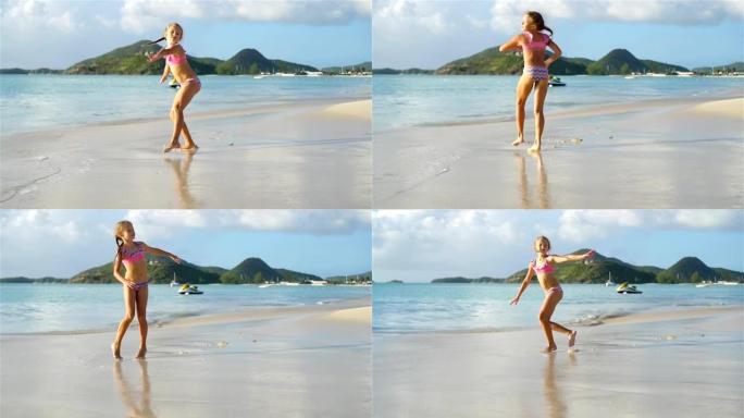 活跃的小女孩在白色海滩上做侧翻