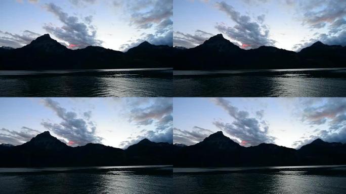 瑞士中部山脉和湖泊的壮丽全景。夕阳把云彩涂上了宏伟的色彩。宽镜头。