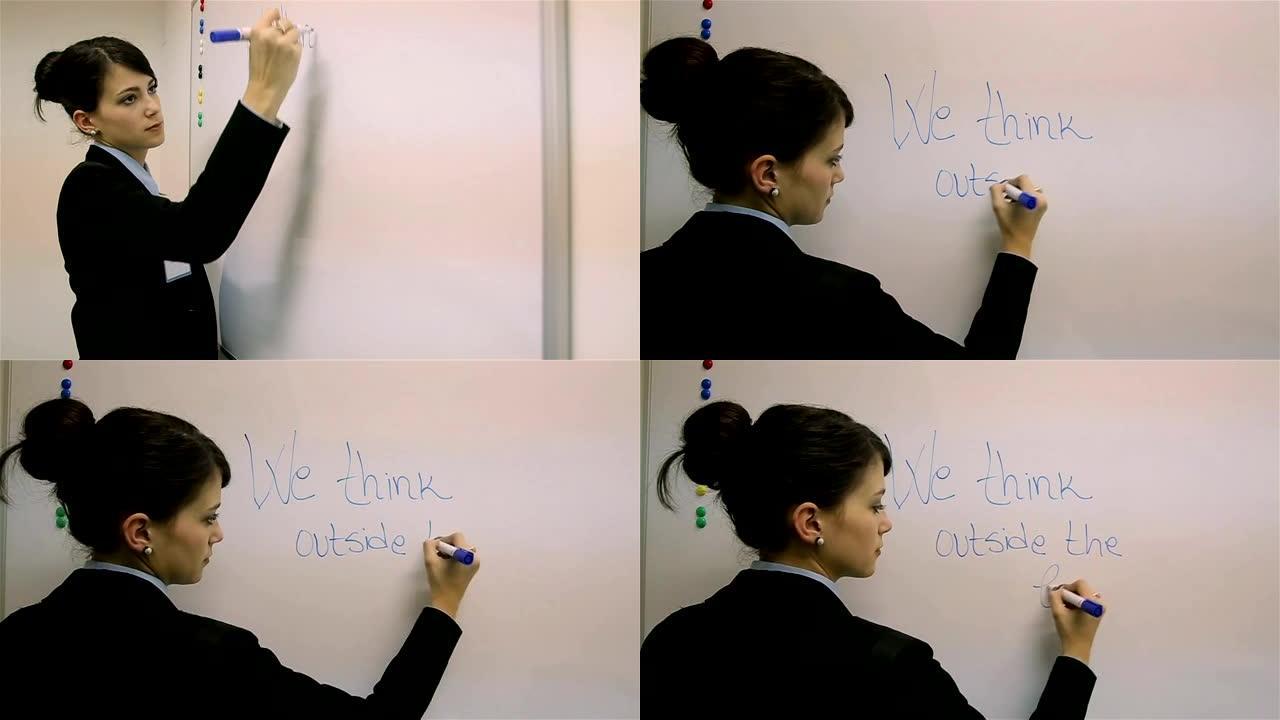 一位年轻的女士在黑板上写下了公司的激励口号