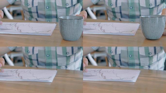 商人从咖啡馆的桌子上拿咖啡杯的特写镜头，慢动作