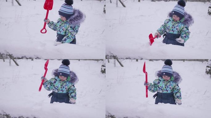 一个在冬季公园玩雪的小孩。阳光明媚的冬日。新鲜空气中的乐趣和游戏。