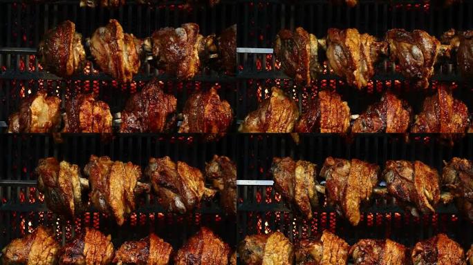 在旋转烤架上慢慢煮熟的猪肘