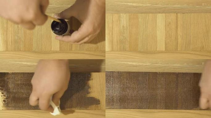 用油漆涂抹亚麻籽木材处理油的人的手的特写。