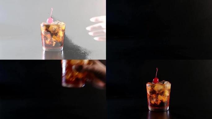 A hand picks up an alcoholic cocktail drink with c