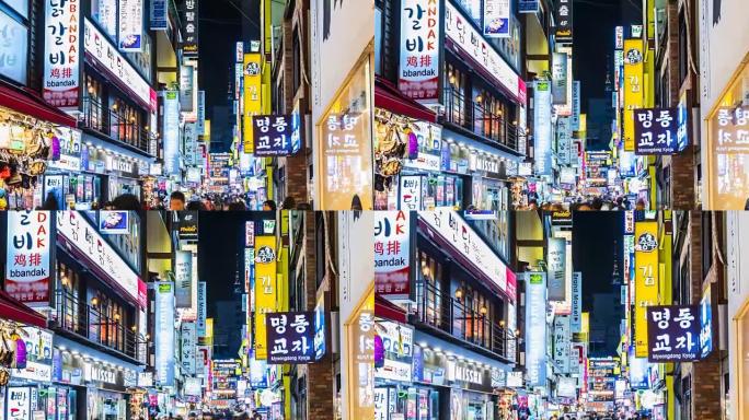 明洞市场的延时。韩国首尔，人们晚上在购物街上散步