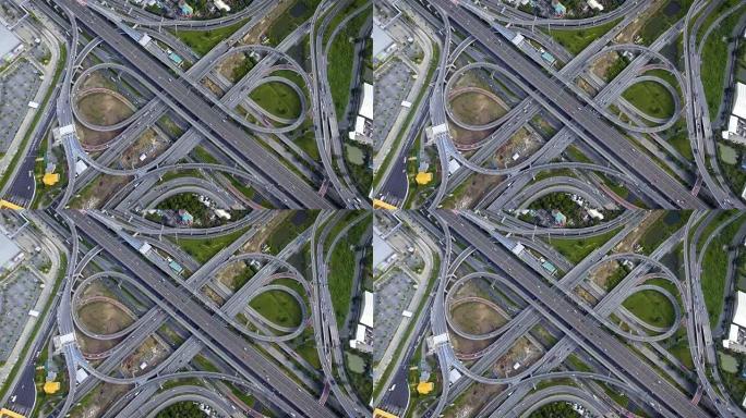 高速公路交汇处的鸟瞰图，繁忙的城市交通在道路上超速行驶