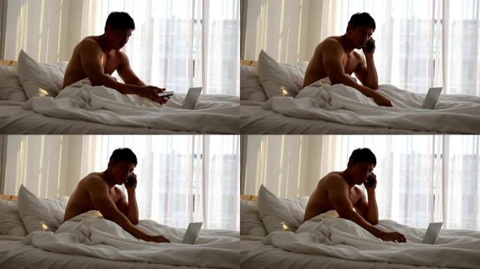 男子在卧室使用笔记本电脑