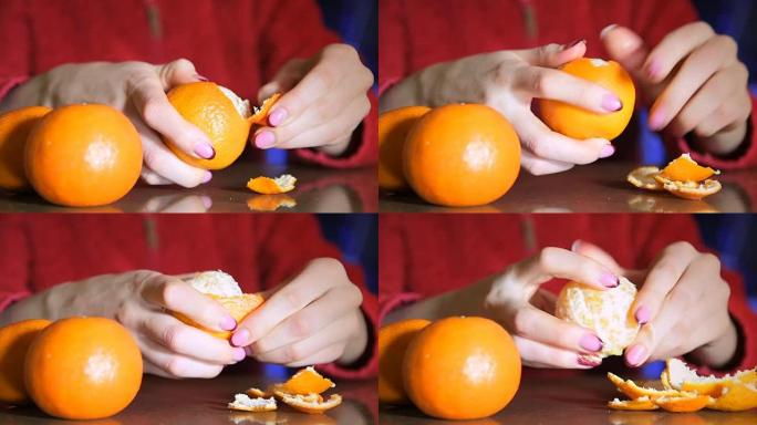 女人从果皮上剥橘子的手的特写