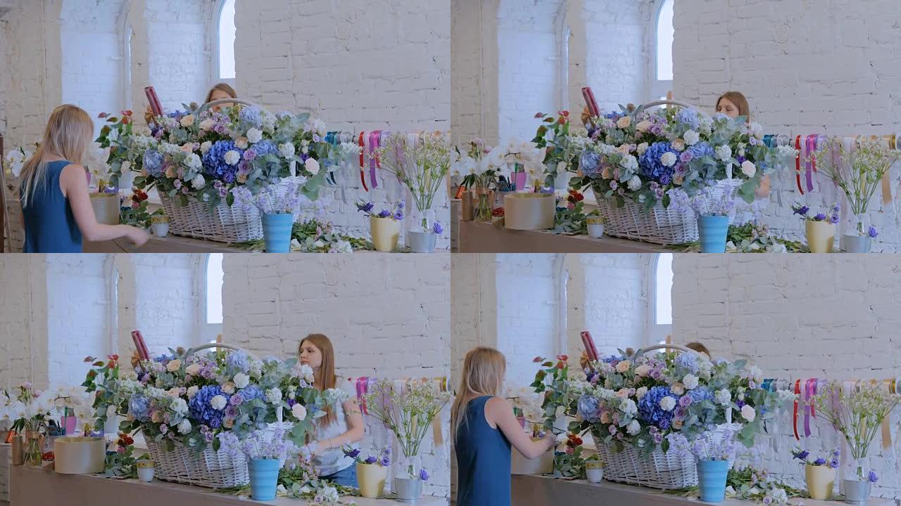 两名女花店在花店用鲜花制作大花篮