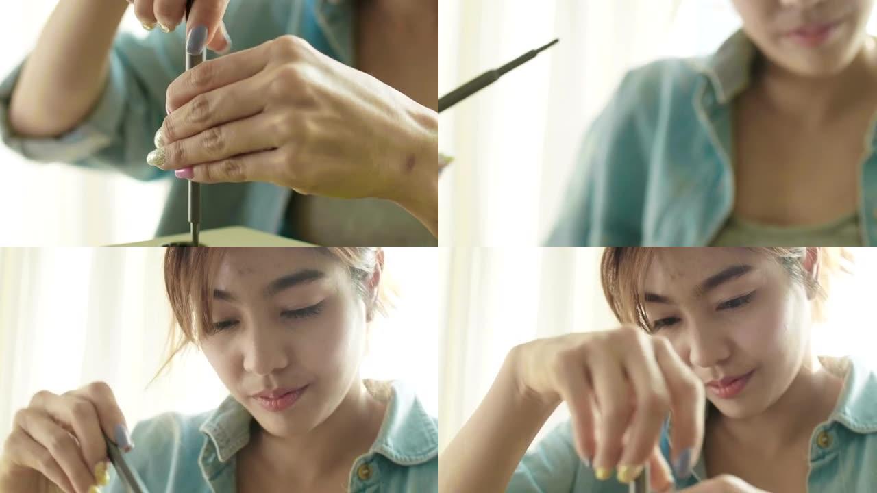 DIY: 亚洲女人用螺丝刀修理木钟