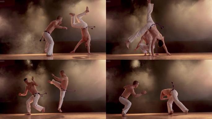 Two athletic men performing capoeira fight on spor