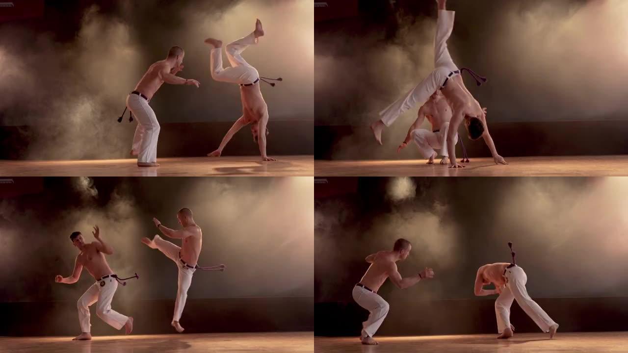 Two athletic men performing capoeira fight on spor