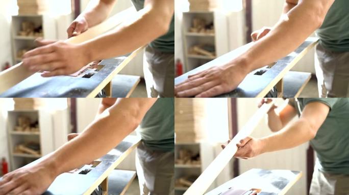 男性工匠研磨长木板条。