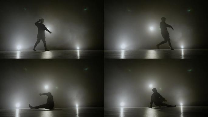 作为著名艺术家音乐视频的一部分，穿着破烂衣服的年轻人在舞台上跳舞现代霹雳舞