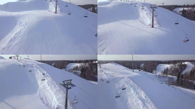 滑雪电梯，用于滑雪冬季度假胜地雪山上的运输滑雪者和滑雪者的鸟瞰图。雪坡无人机景观绳索路上的滑雪椅
