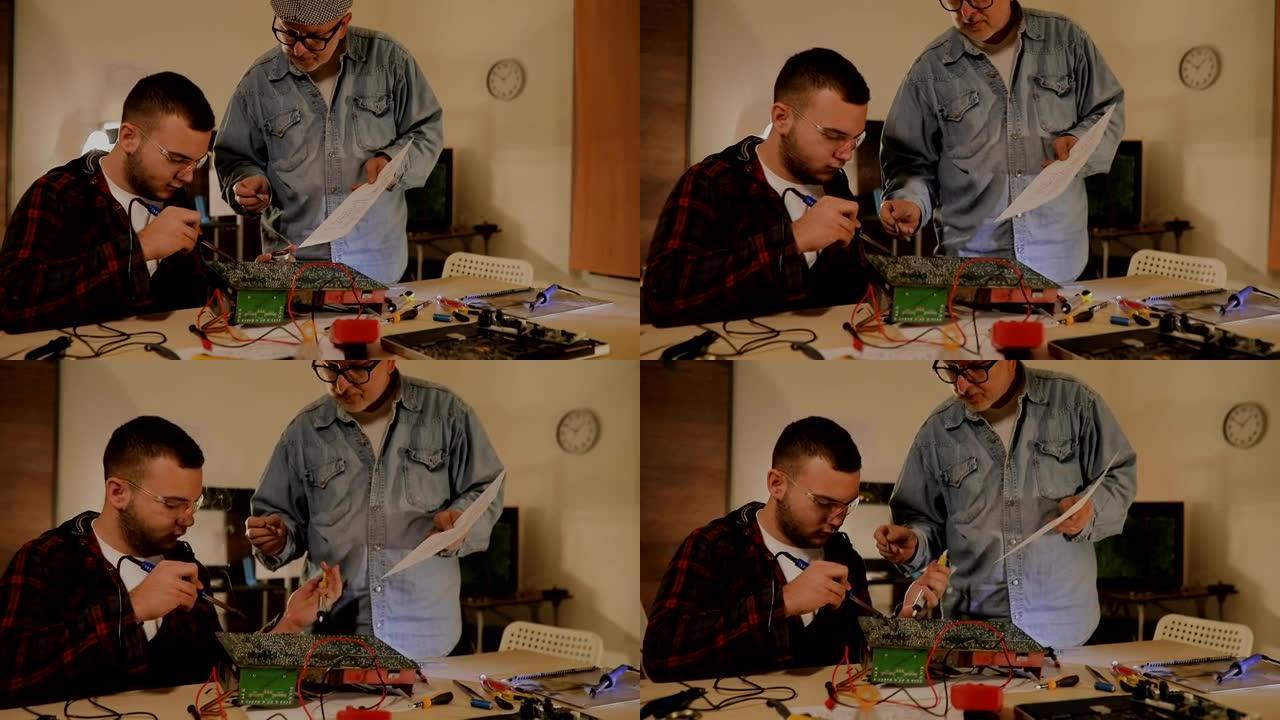 两个男工程师试图通过焊接来修复电路...