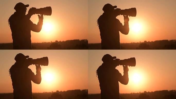 男人在风景秀丽的日落时用数码相机拍照。慢动作镜头