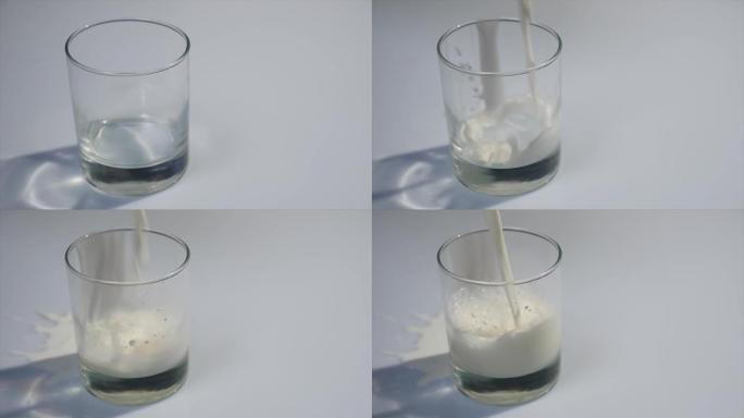 将牛奶倒入玻璃杯中。白色牛奶装满透明玻璃。牛奶倒在白色背景前