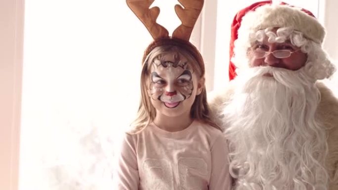 Santa and girl wearing reindeer antler headband