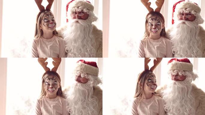 Santa and girl wearing reindeer antler headband