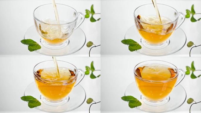 热凉茶配姜、柠檬和薄荷。透明茶壶中的生姜饮料。健康柠檬茶。