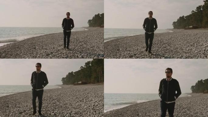 一个孤独的人在石质海滩上漫步，海浪拍打着岸边