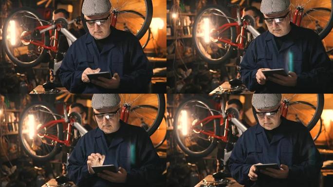 修理工用平板电脑在车间修理自行车