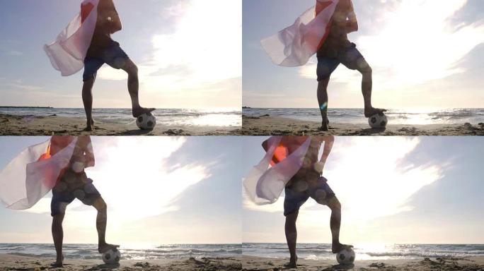 戴着日本国旗的年轻人作为超级英雄斗篷，脚踩着足球站在海边的沙滩上，日落时看着海滩上的海洋摄像机ste