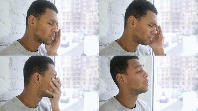 非洲裔美国年轻人头痛的特写镜头，窗户