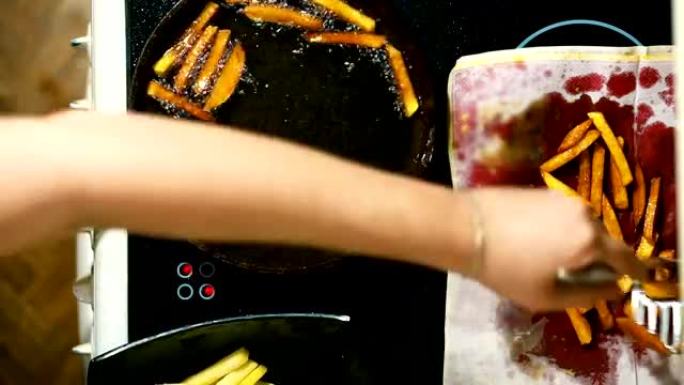 手准备炸薯条的特写镜头。炸土豆放在餐巾纸上。