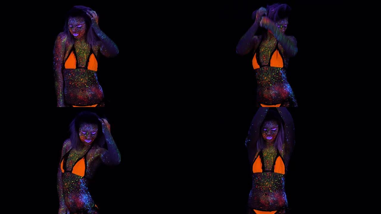 美丽的时尚女人在霓虹紫外光中跳舞的肖像。荧光创意迷幻化妆模特女孩，UV中女性迪斯科舞者模特的艺术设计