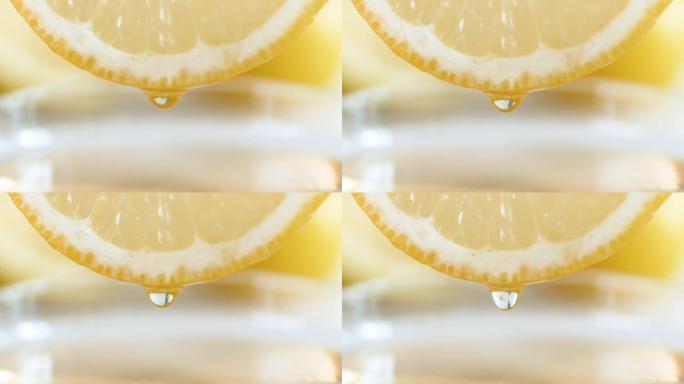 特写慢动作视频，果汁滴从柠檬片的侧面慢慢滴落