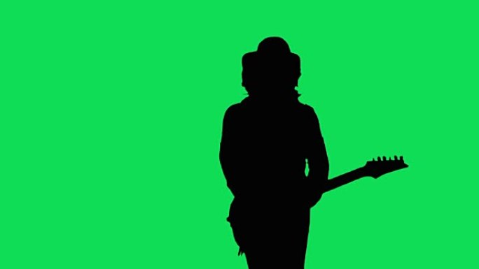 帽子里的酷摇滚吉他手在绿屏上弹奏电吉他