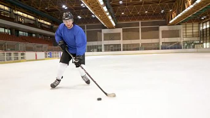 Young ice hockey player tackling and shooting at g