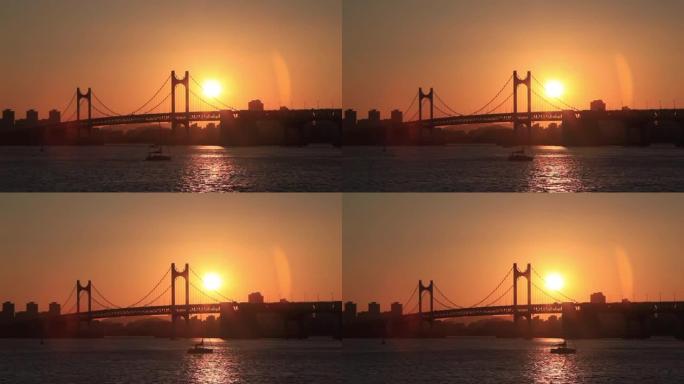 穿过釜山广安大桥红光的游艇。