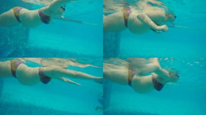 孕妇在游泳池游泳的水下视图