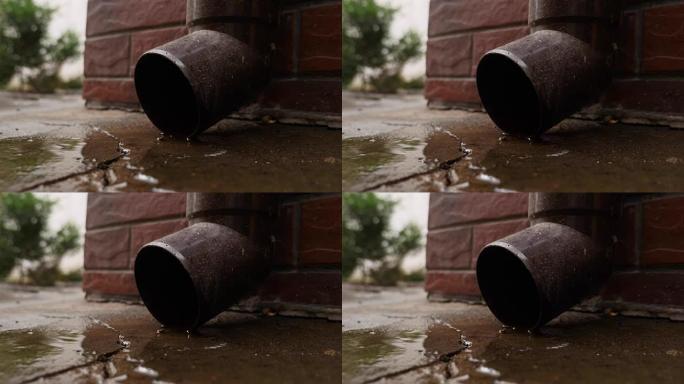 锡水运行排水管和水滴下降。雨水聚集