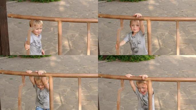 小男孩爬上公园凉亭的篱笆。