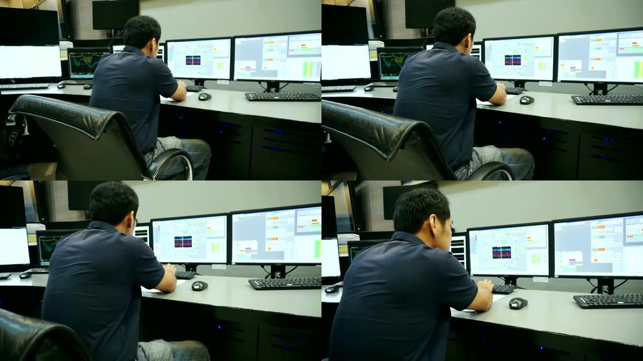 男性亚裔工程师在控制室工作