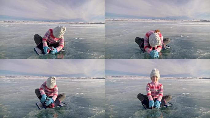 女孩在冬天练习瑜伽。孩子们在大自然的冰上做伸展运动和冥想。孩子们练习瑜伽，用碎冰做麻绳。孩子们在户外