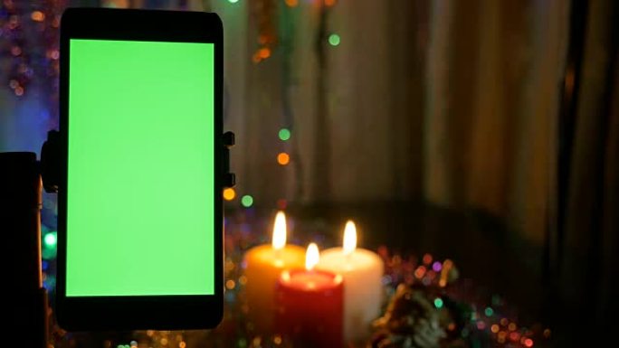 绿屏智能手机。新年灯光模糊背景。