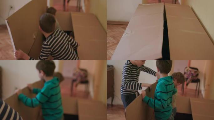 Kids playing with cardboard box, handheld shot
