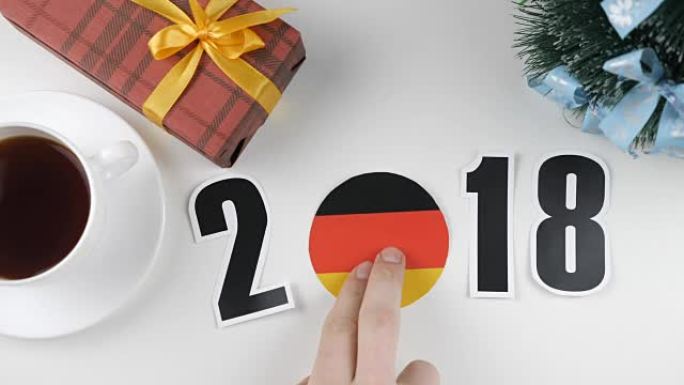 插图，新年，男性手放在桌子上德国国旗，cauntry球，2018
