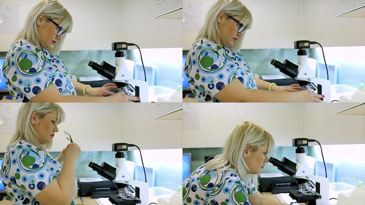 Female scientist working in ab with microscope. cl