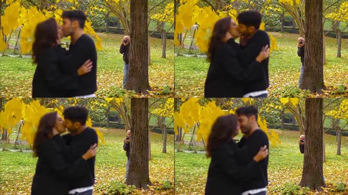 间谍，摄影摄影师发现一对情侣在公园里接吻
