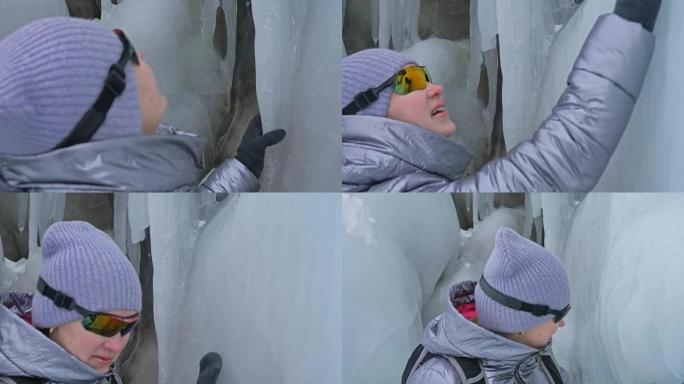 女人在贝加尔湖冰上的旅行。去冬日岛旅行。女孩正走在冰石脚下。旅行者看着美丽的冰窟。极度跋涉和行走。背