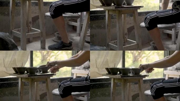工艺陶瓷的小企业; 靠近陶工的手，用投掷陶瓷工艺在圆轮上制作一个杯子-股票视频