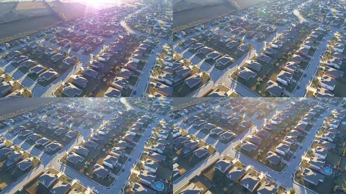 阳光光束和房地产市场爆炸的无人驾驶飞机视野郊区，完美的小盒子房子排成一排