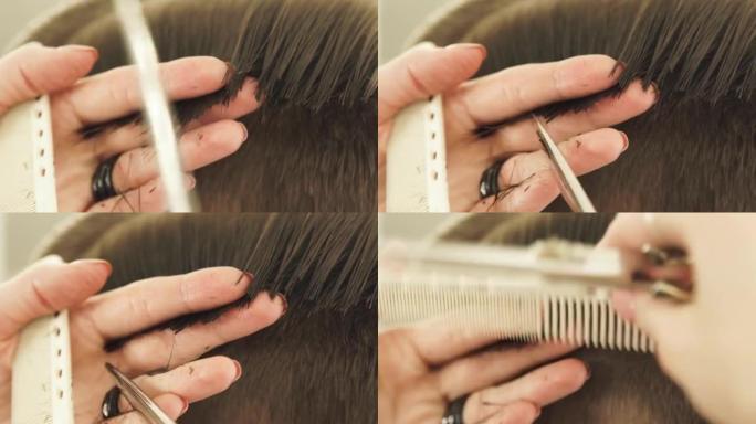 手发剪梳理湿头发，并使用美发剪刀进行近距离切割。理发店用梳子和美发剪刀做男性发型的理发师
